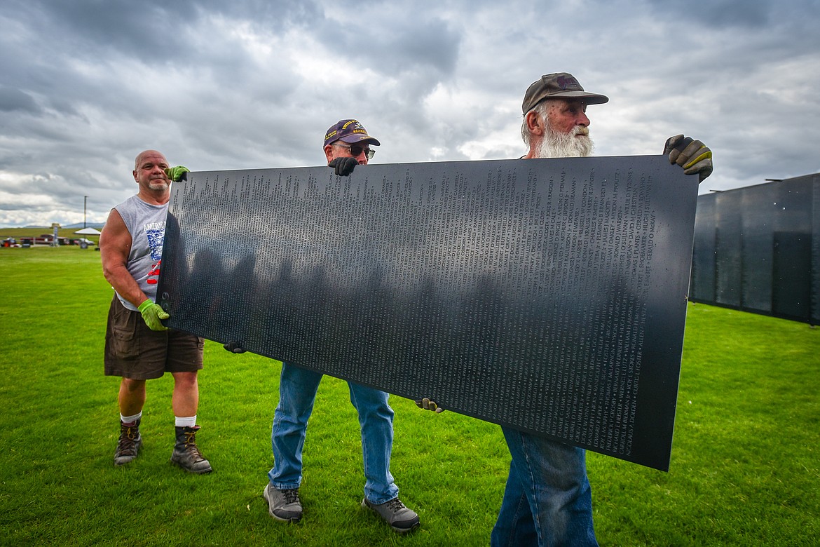 From left, veterans Dale DeZort, Art Bielz and Glenn Wehe carry the last panel to be put in place for The Wall That Heals at the Glacier High School soccer fields on Wednesday, June 21. The Wall That Heals is a three-quarter scale replica of the Vietnam Veterans Memorial in Washington D.C. (Casey Kreider/Daily Inter Lake) (Casey Kreider/Daily Inter Lake)