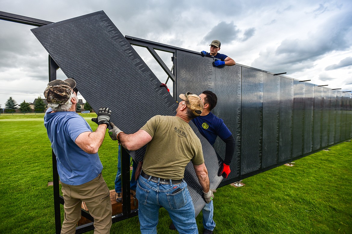 Crews of veterans and volunteers carry the individual panels and manuever them into place at The Wall That Heals at the Glacier High School soccer fields on Wednesday, June 21. The Wall That Heals is a three-quarter scale replica of the Vietnam Veterans Memorial in Washington D.C. (Casey Kreider/Daily Inter Lake)