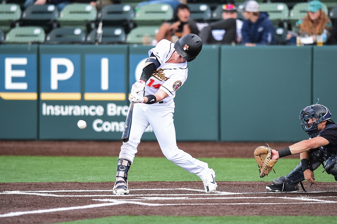 Glacier's Jackson Raper (14) connects on a single in the third inning against the Great Falls Voyagers at Glacier Bank Park on Wednesday, June 21. (Casey Kreider/Daily Inter Lake)