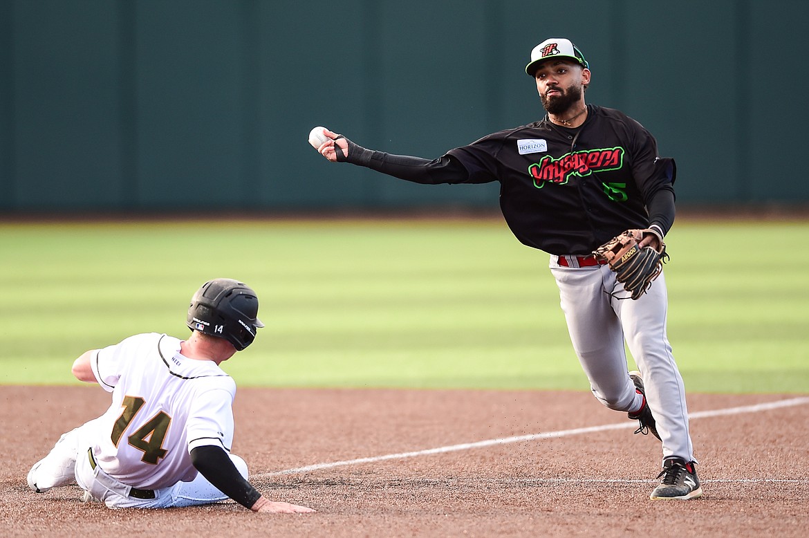 Great Falls shortstop Dilan Espinal (15) turns a double play in the first inning against the Glacier Range Riders at Glacier Bank Park on Wednesday, June 21. (Casey Kreider/Daily Inter Lake)