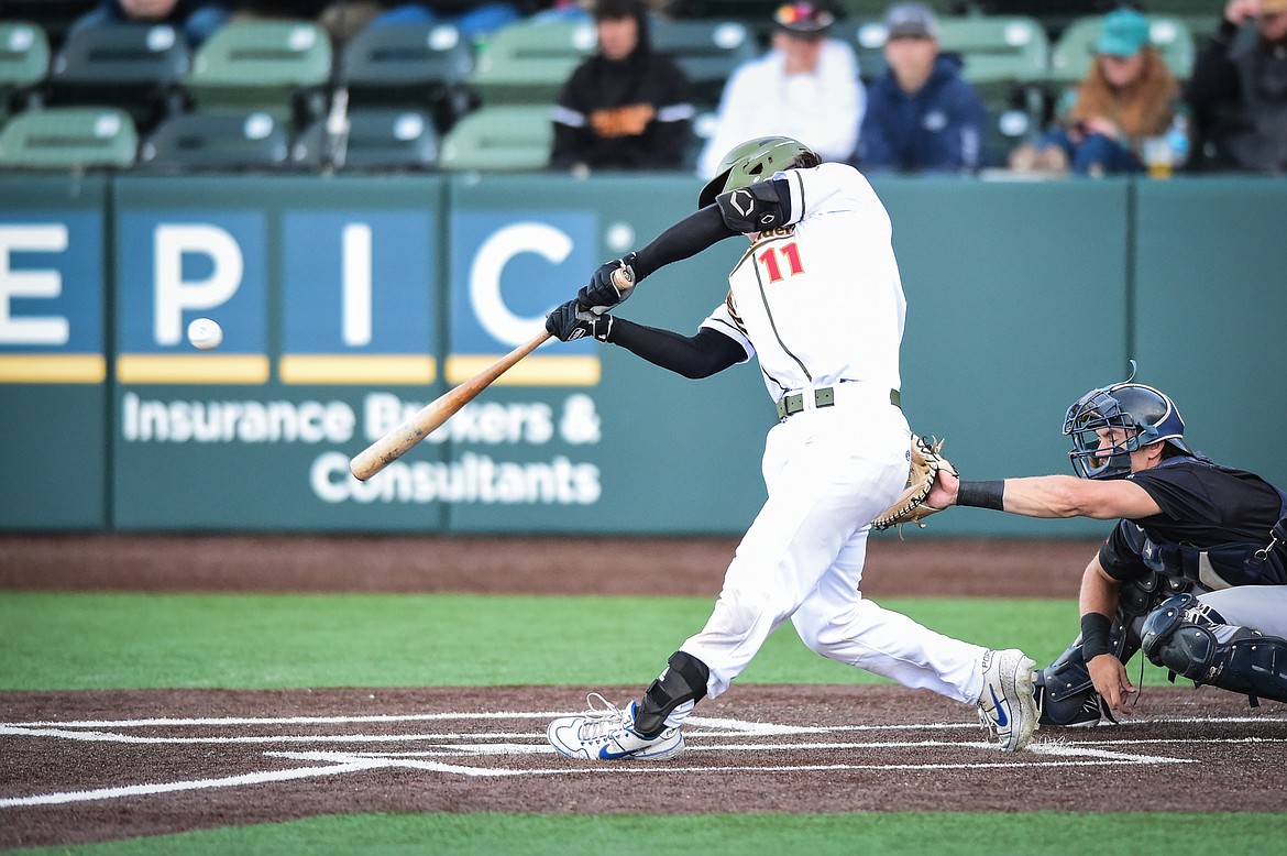 Glacier's Matt Clayton (11) brings in two runs with a single in the third inning against the Great Falls Voyagers at Glacier Bank Park on Wednesday, June 21. (Casey Kreider/Daily Inter Lake)