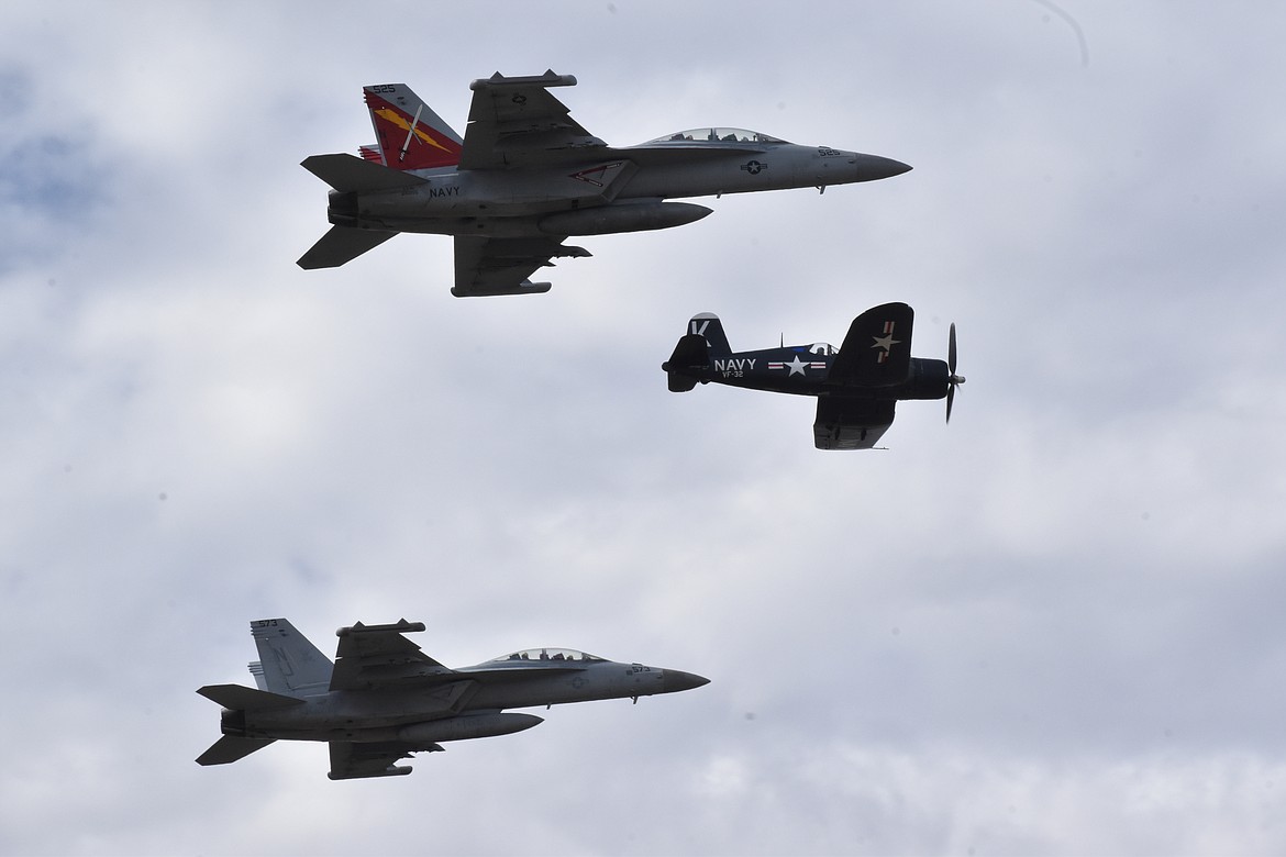 A flyover of American fighter craft shows the breadth of the Moses Lake Airshow with F-18s following a Vought F4U Corsair over the airport. The older aircraft was in production from 1942 to 1953 and were utilized by the U.S. Navy, U.S. Marine Corps, Royal Navy and Royal New Zealand Air Force. The aircraft saw service in World War II and the Korean War.