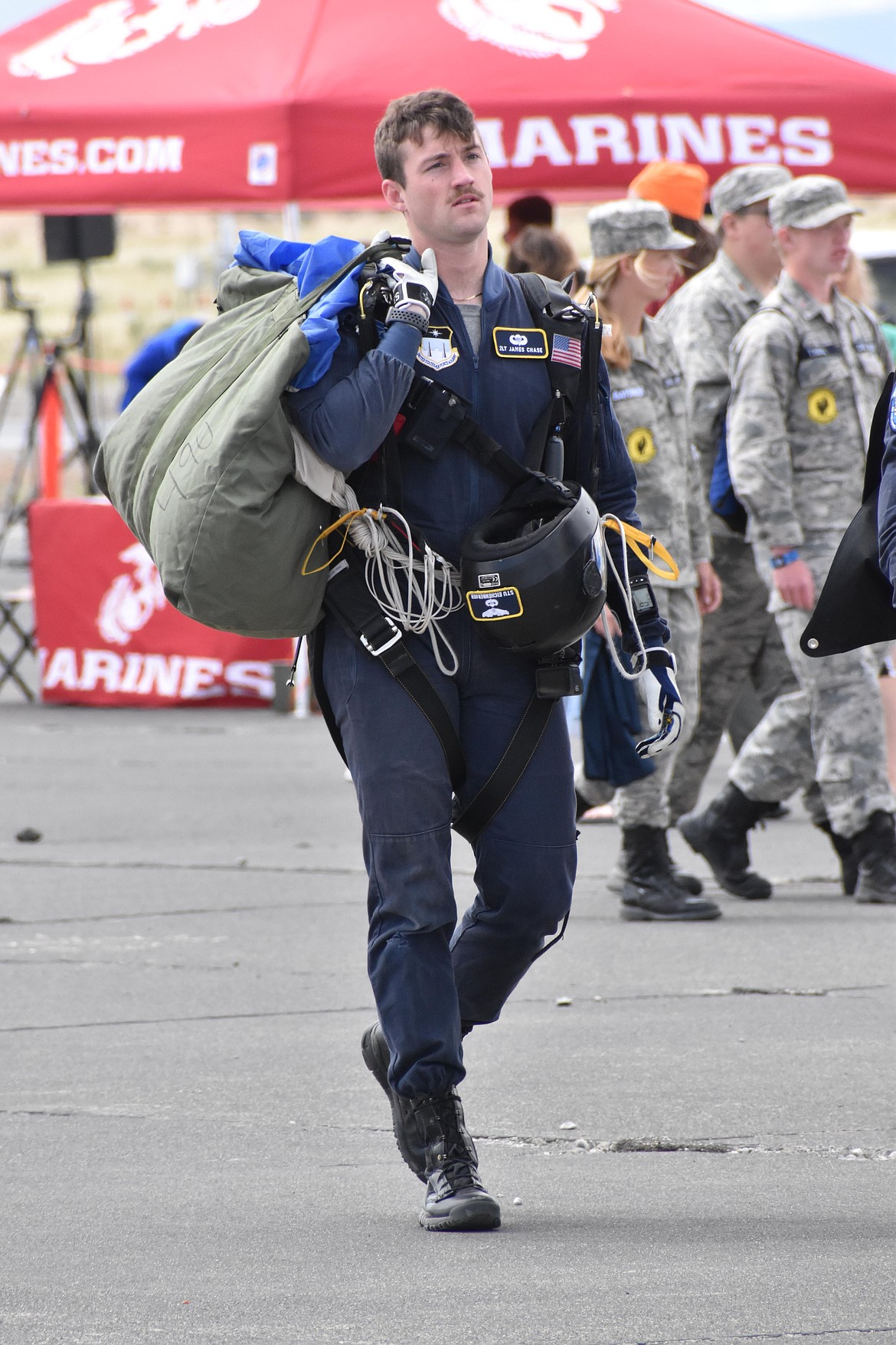 Second Lt. James Chase of the U.S. Air Force Academy carries his gear on the tarmac at the Moses Lake Airshow. The show gives civilians an opportunity to interact with service members from nearly all of the branches of the U.S. military.