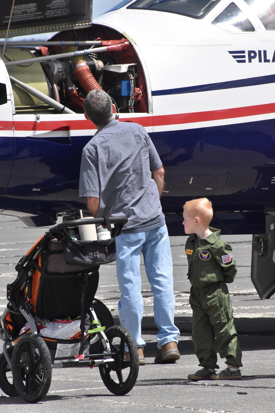 A family looks over the inner workings of an airplane at the Moses Lake Airshow. Organizers have said airshows inspire young people to consider becoming pilots and help adults enjoy their fascination with flight.
