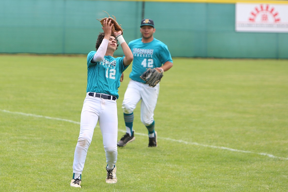 River Dog shortstop Cruz Martinez (12) catches a fly ball in foul territory for an out.