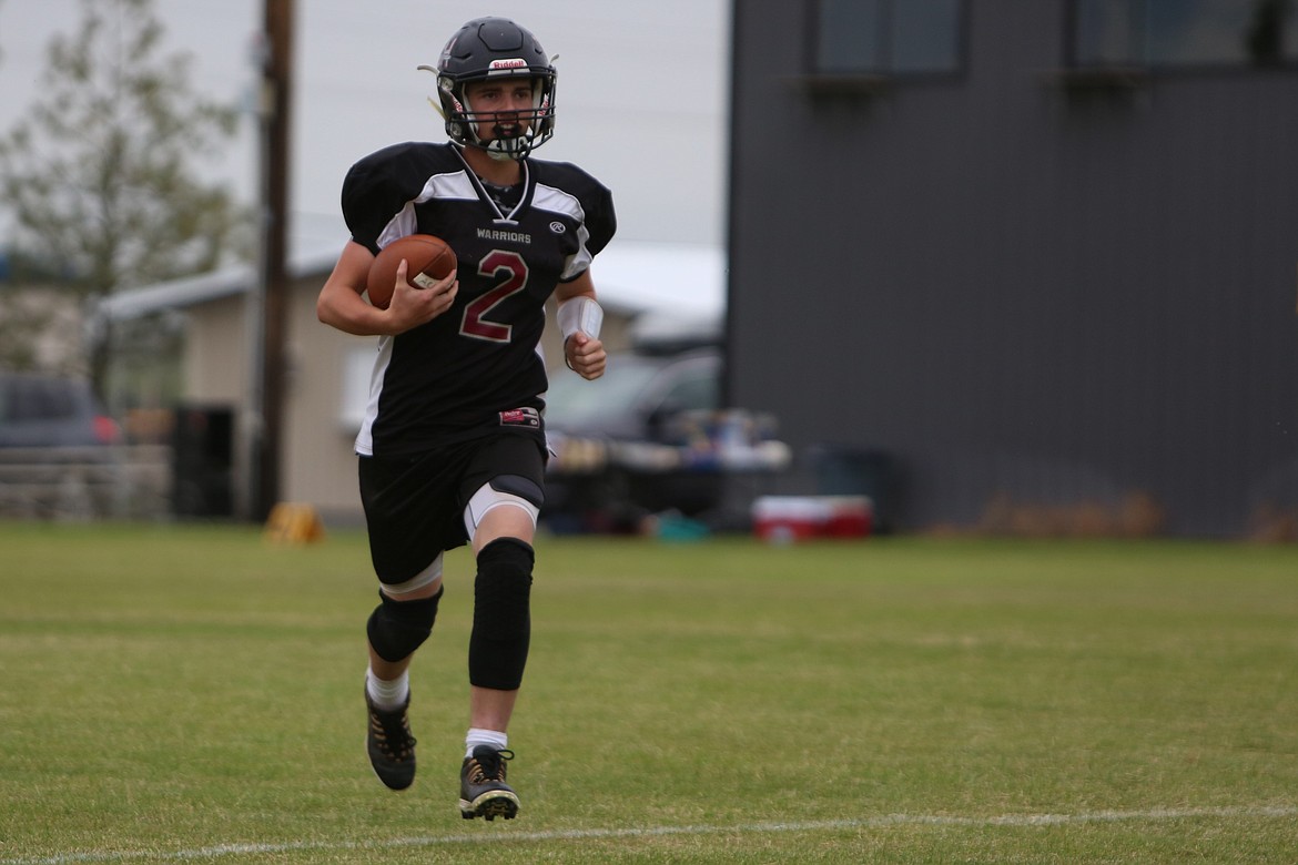 An ACH quarterback runs into the end zone after keeping the ball on an option play against the Wellpinit defense.