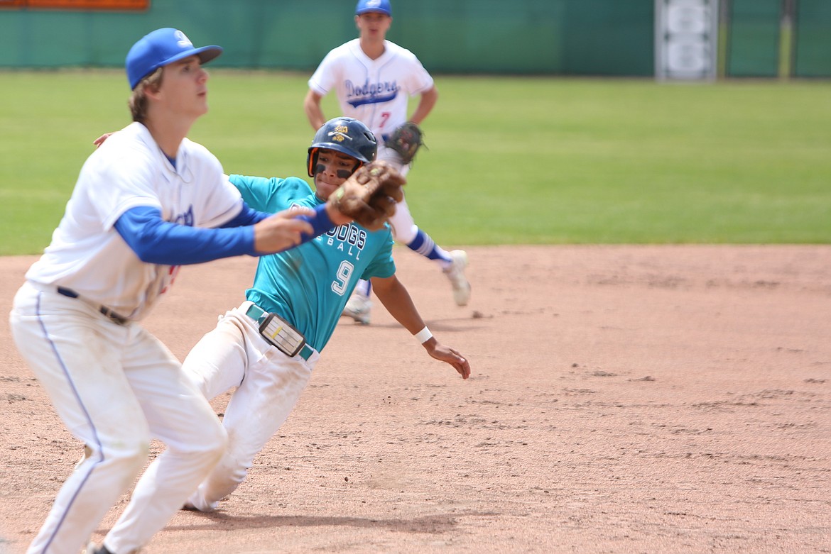 River Dog center fielder Jackson Carlos slides into third base to beat the incoming tag.