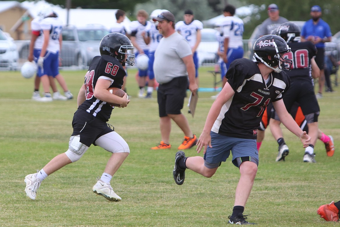 An ACH ball carrier runs with a wall of blockers towards the defense’s end zone.