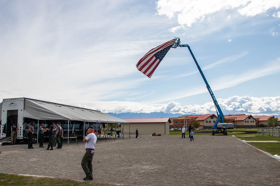 An American flag flys as volunteers assemble The Wall That Heals on June 21, 2023 at Glacier High School. (Kate Heston/Daily Inter Lake)