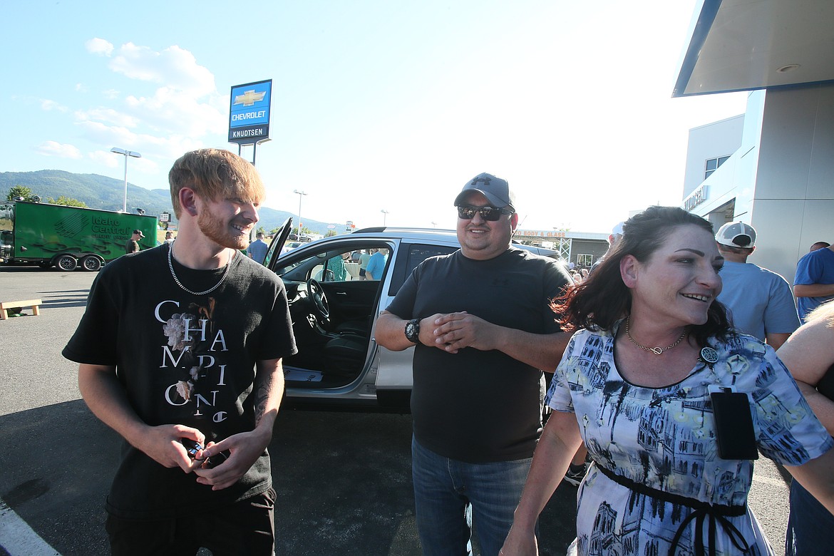 Brian Stamper-Schaeffer Jr., left, with dad Brian Schaeffer Sr. and mom Tera Stamper share a joyful moment Thursday at Knudtsen Chevrolet after the 2023 Timberlake High School graduate won a new car.