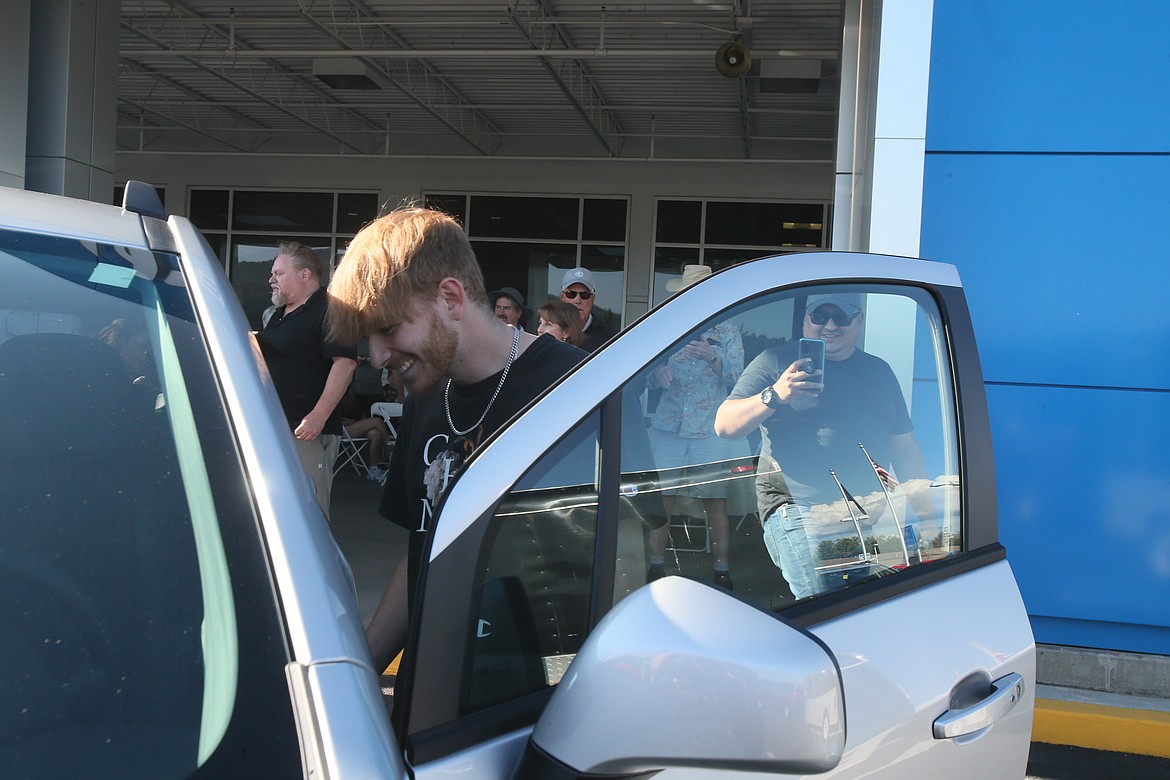 Brian Stamper-Schaeffer Jr. smiles as he gets into his new 2022 Chevy Trax for the first time Thursday evening after winning it at the annual Knudtsen Chevrolet celebration and car giveaway.