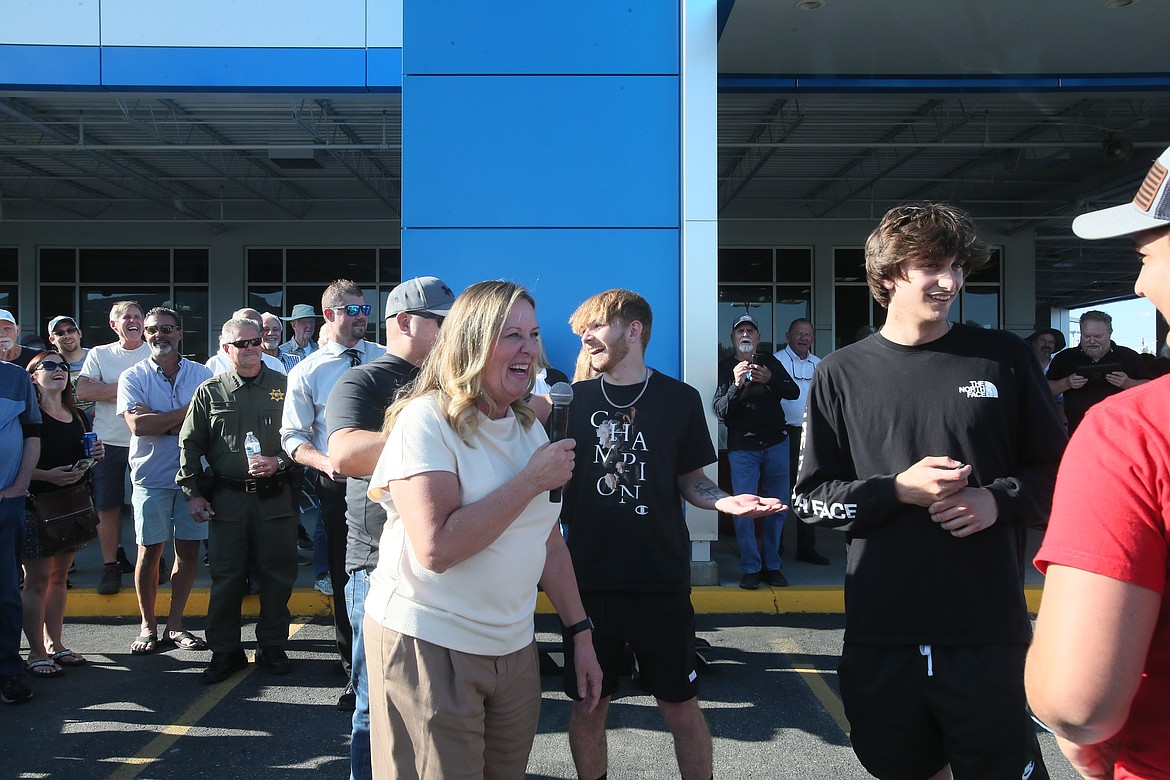 Knudtsen Chevrolet President Eve Knudtsen, center, is all smiles Thursday evening after a Timberlake High School grad wins a new 2022 Chevy Trax on the first try during the dealership's annual community celebration.