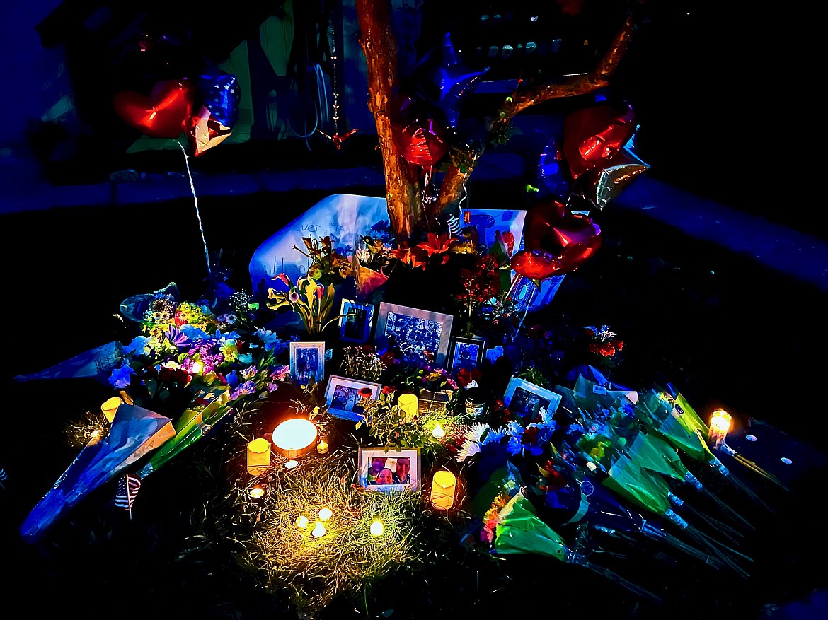 A small shrine was erected on the lawn in front of Aiken Smith's home during a brief vigil that was held for him on Wednesday evening.