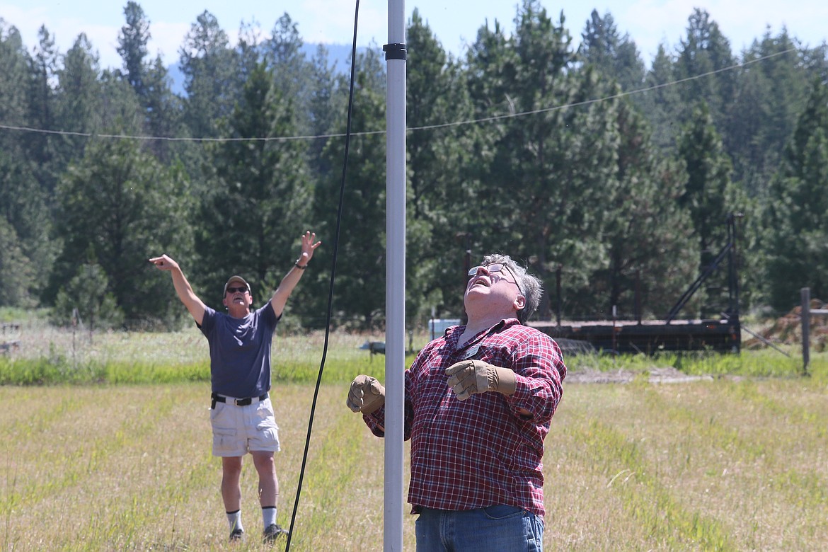 Mark Mayer, left, and Mike Glauser work to set up an antenna Friday morning for the annual Amateur Radio Field Day exercise, which begins at 11 this morning and goes through 11 a.m. Sunday.