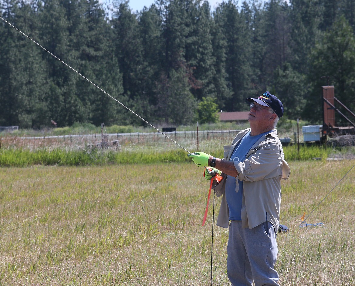 Lifelong ham radio enthusiast Jim Fenstermaker holds a wire as he and other Kootenai Amateur Radio Society members raise antennas Friday morning for a weekend-long Amateur Radio Field Day exercise.