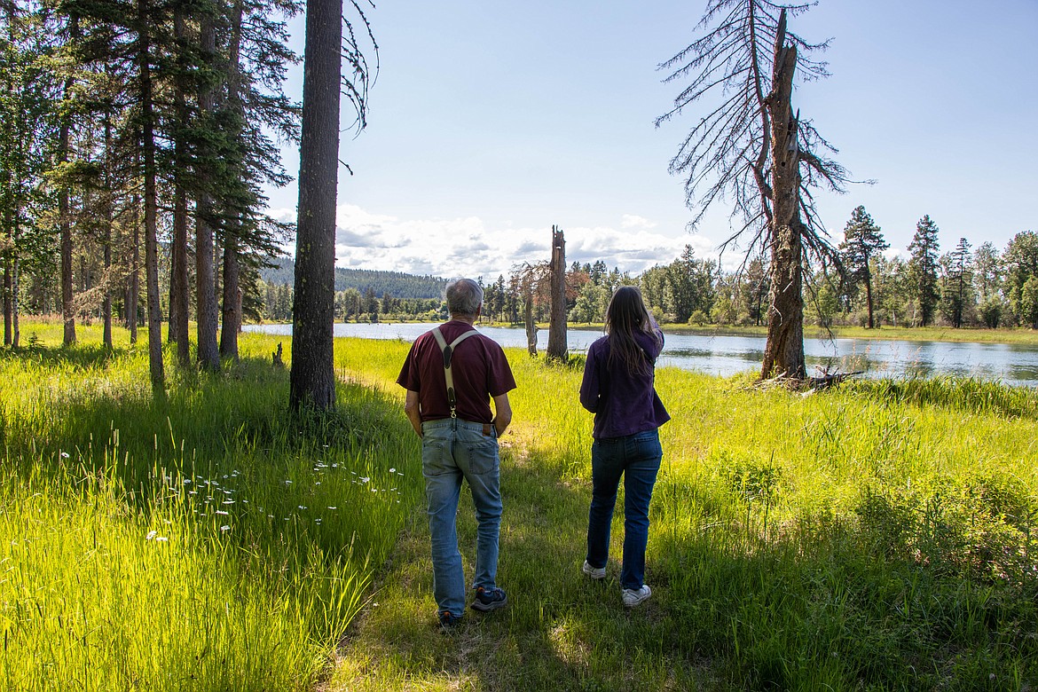 Ed Goldberg walks on his property along the Swan River east of Bigfork on June 22, 2023 next to Laura Katzman with the Flathead Land Trust. Goldberg just placed his 40 acres under a conservation easement. (Kate Heston/Daily Inter Lake)