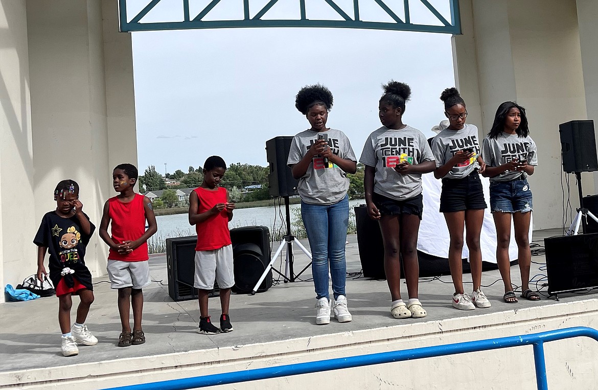 Area youth speak from the McCosh Park Amphitheater to attendees of the Juneteenth celebration about what the holiday means to them.