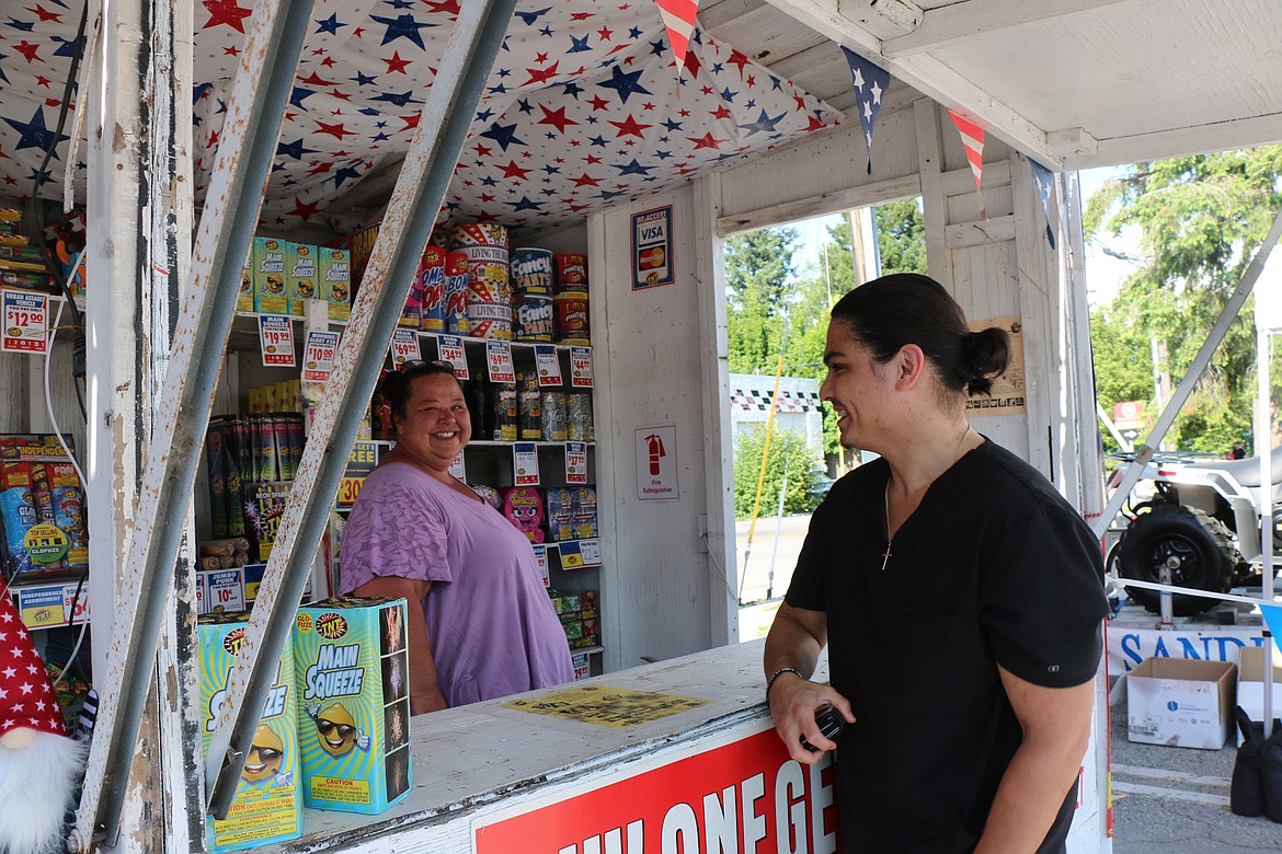 Faith Brown helps Graham Andrews as he selects fireworks at the Sandpoint Lions fireworks stand. Located in the northwestern corner of the Safeway parking lot, 702 N. Fifth Ave., proceeds will go toward the community fireworks show.