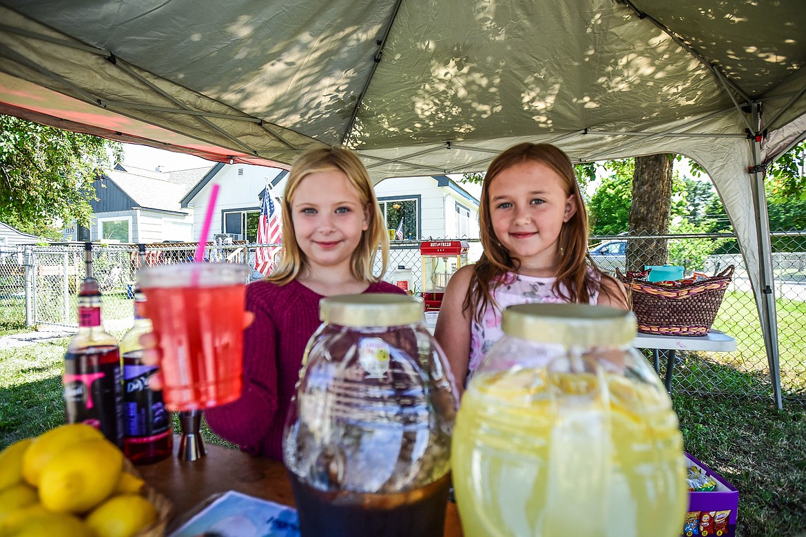 Sophia Derozier and Ava Milutinovic operate the Sour Fairy Sips stand featuring freshly-squeezed and flavored lemonades like huckleberry and raspberry, iced tea and cotton candy as part of the Lemonade Day program on Saturday, June 24. (Casey Kreider/Daily Inter Lake)