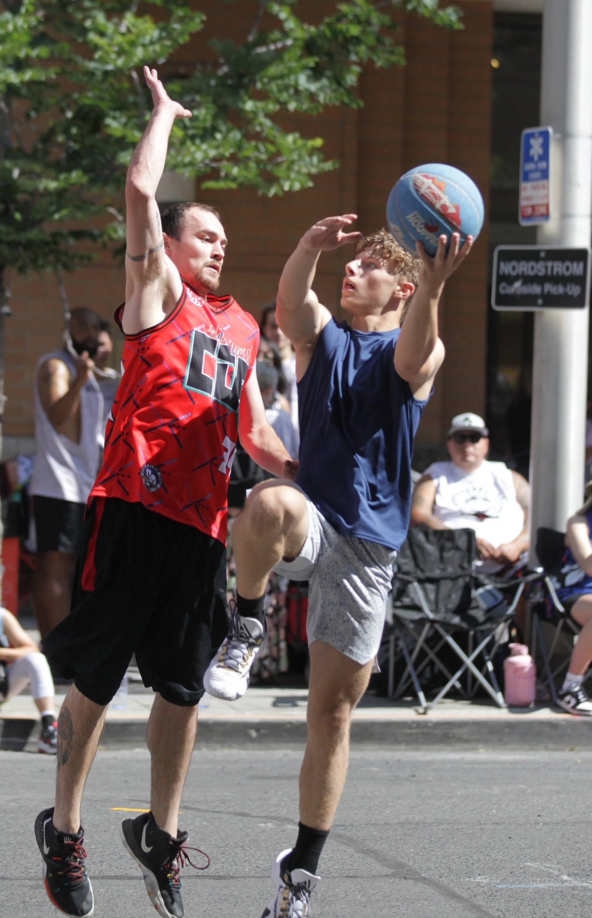 MARK NELKE/Press
Cooper Miller, right, of Miller Cup puts up a shot against Joseph Nomee of Cuzzos on Saturday at Hoopfest in downtown Spokane.