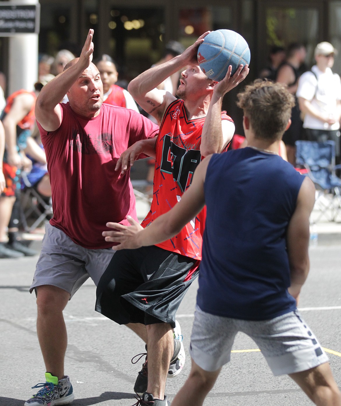 MARK NELKE/Press
Corey Miller, left, of Miller Cup defends as Joseph Nomee of Cuzzos drives during Hoopfest on Saturday in downtown Spokane.