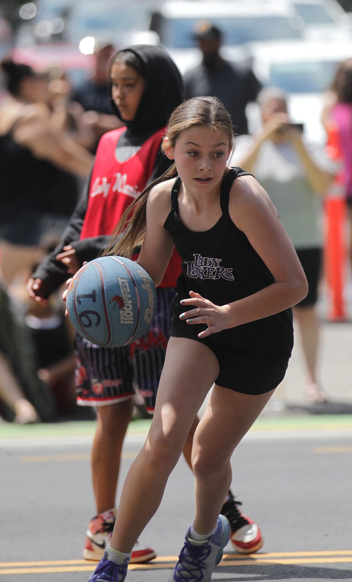 MARK NELKE/Press
Gretah Angle of the Cd'A Lakers dribbles out after collecting a rebound Saturday at Hoopfest in downtown Spokane.