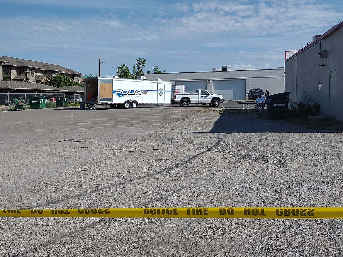 Kalispell Police officers investigate the scene of an alleged homicide in a parking lot off Appleway Drive and Meridian Road in Kalispell on Sunday, June 25, 2023. (Derrick Perkins/Daily Inter Lake)