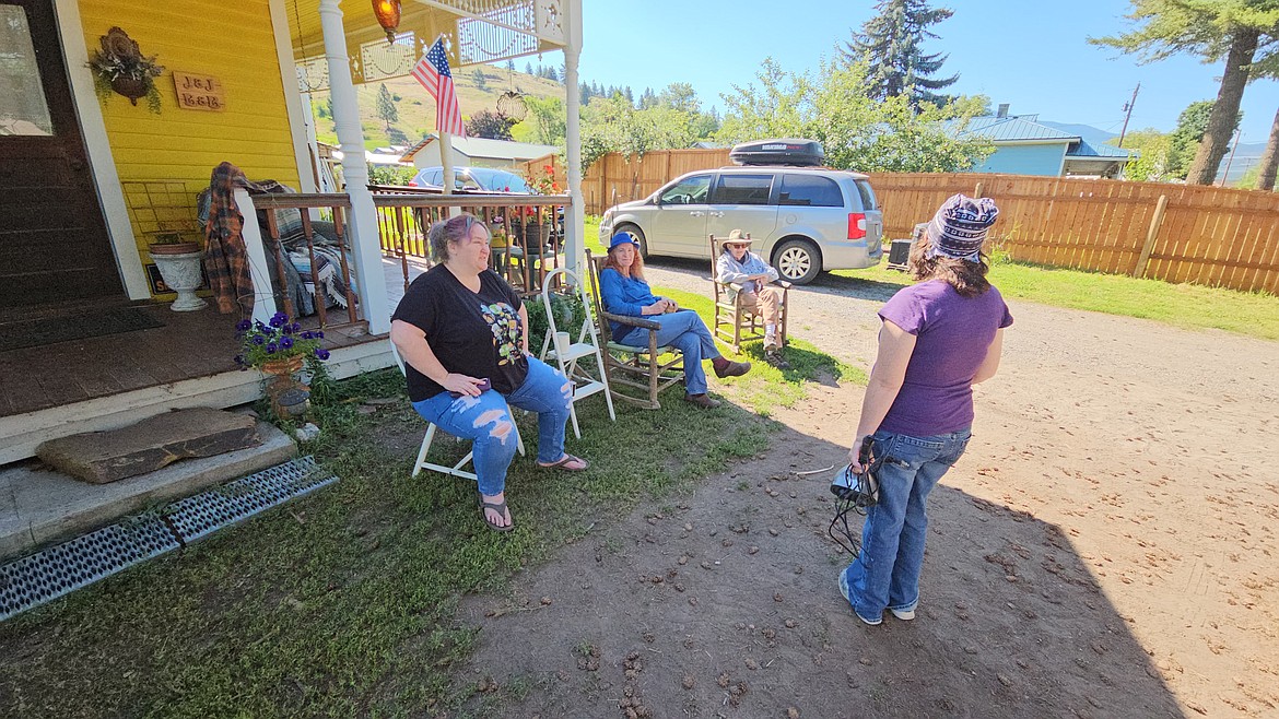 Yard salers Debbie Wartha (left) and Joanne Mathers (in chair) greet a yard sale shopper during their Sanders County Yard Sale-ing event this past weekend in Plains. (Chuck Bandel/VP-MI)