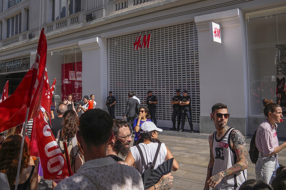 H&M staff protest in front of a closed H&M store in Madrid, Spain, Monday, June 26, 2023, to demand better conditions in a physical retail environment. More than 4,000 retail workers across Spain were called to a new round of strikes against fashion giant H&M Group on Monday, extending a series of store closures in the middle of the summer sales season. (AP Photo/Paul White)