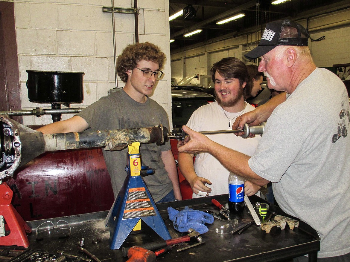Volunteer and Glacier Street Rod Association member Greg Greene assists Flathead High School automotive students Tharen Gheen, left, and Zach Roker with a 1928 Model A project. (Photo courtesy of Rodney Bauman)