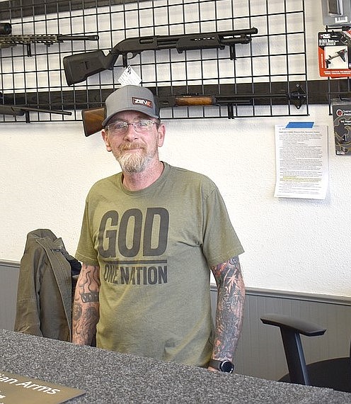 Guardian Arms owner Bruce Davis stands in his Moses lake shop. Davis and other plaintiffs filed a suit against the state after an assault weapons ban was enacted in late April.