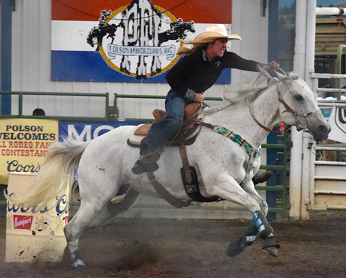 Kelsie Wolfe, Boulder, scampers around the barrels on her grey horse during the Ladies barrel Racing. (Berl Tiskus/Leader)