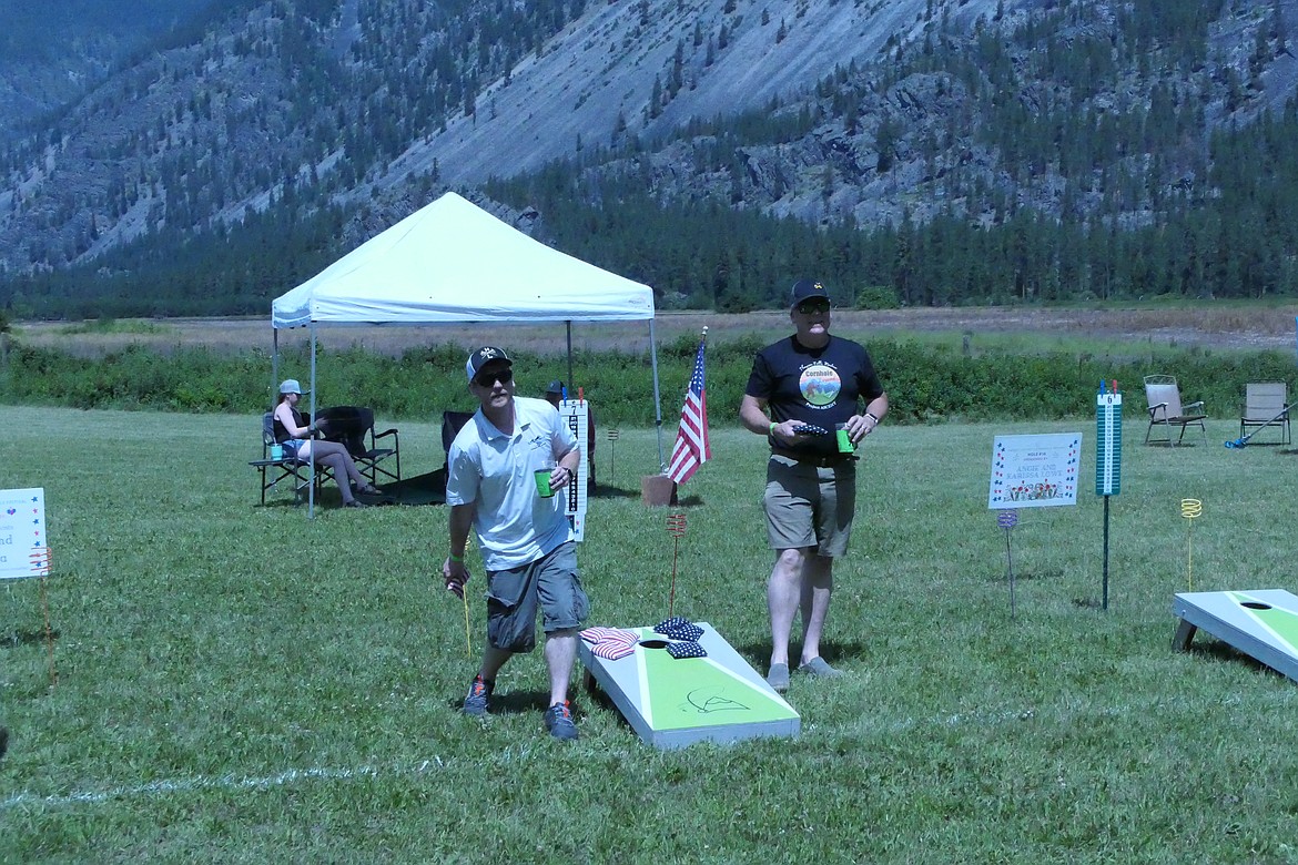 Thompson Falls residents Cody Mosher (left) and Michael Beckman get in some warm-up tosses prior to the start of this year's Cornhole Festival on Eddy Lane off Highway 200 this Saturday. (Chuck Bandel/VP-mi)