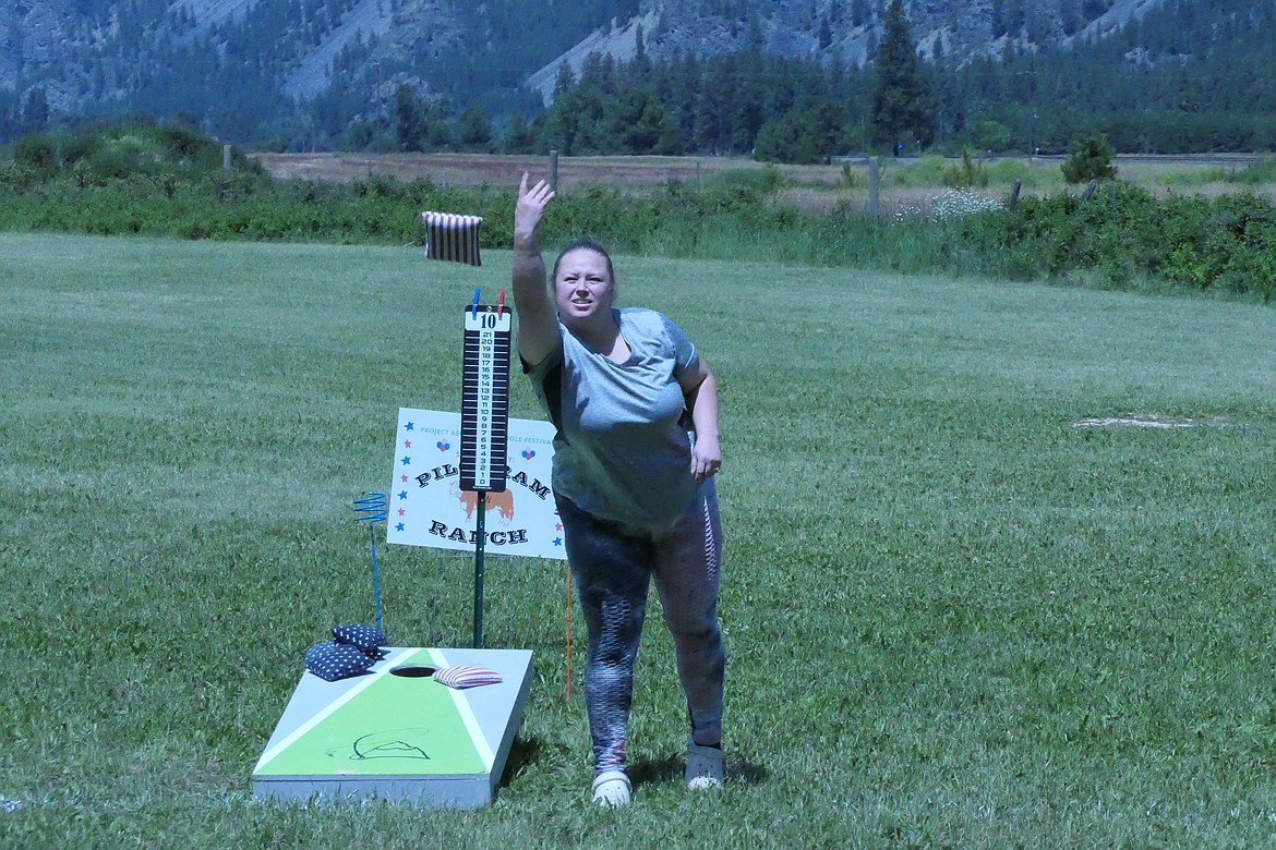 First time Cornole tourney participant Aleesha Graves, from southern Idaho, lets a bag fly during Saturday's Cornhole Festival between Thompson Falls and Plains. (Chuck Bandel/VP-MI)