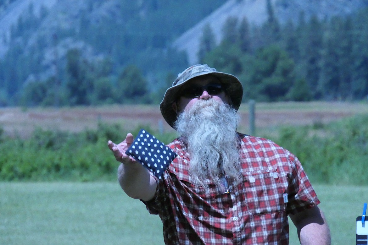 Southern Idaho entrant Troy Graves lets a patriotic bag fly during Saturday day's Cornhole Festival on Eddy's Lane between Plains and Thompson Falls.  The tournament was held to help fund Project Ascent, an area youth help charity.  (Chuck Bandel/VP-MI)