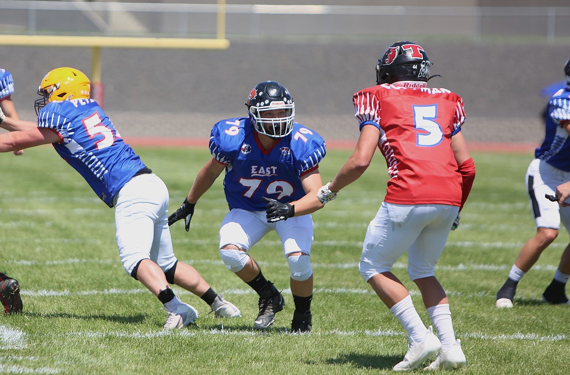 Ephrata offensive lineman Wes Kriete (79) looks toward a West defender before blocking him on a run play.