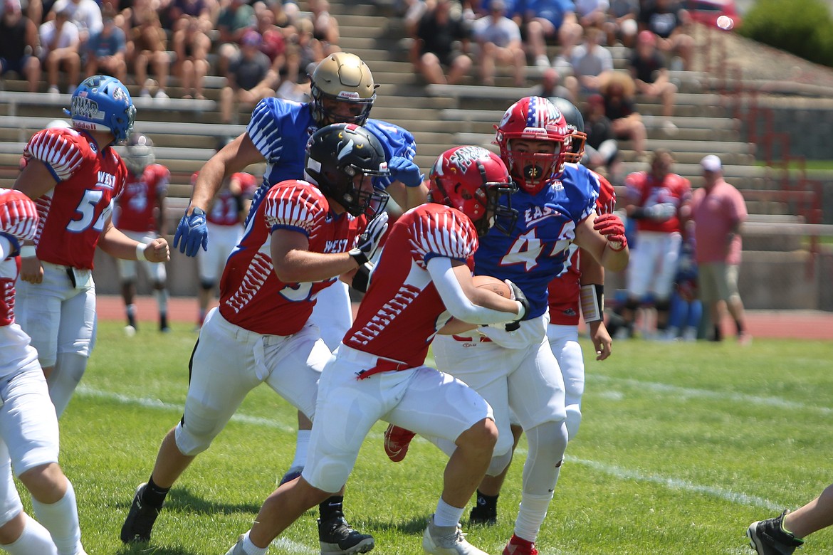 Othello defensive lineman Julian Alegria (44) makes a tackle during the first half of the Earl Barden Classic.