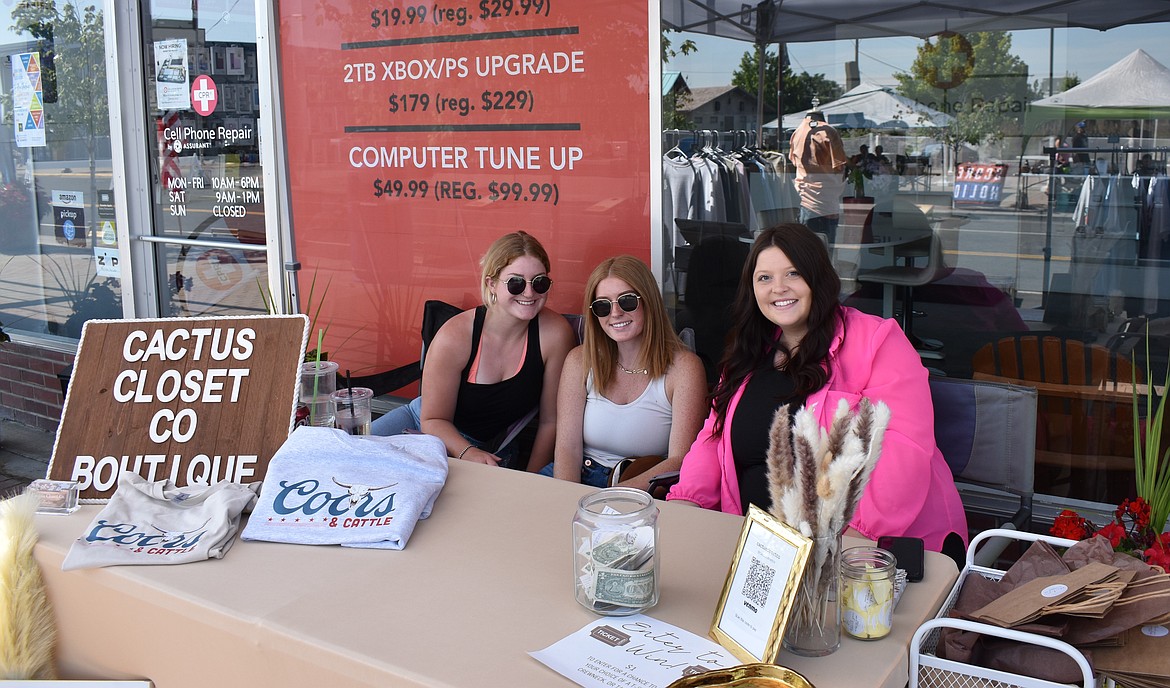 Staff man the Cactus Closet Boutique booth during the celebration on Saturday. The online boutique participated in the event to support other downtown businesses.