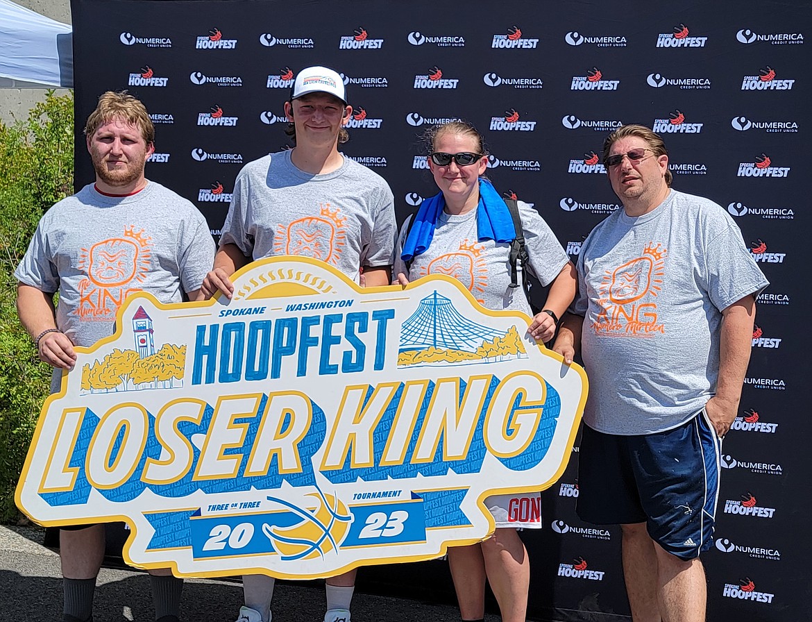 Team Roopaway poses for a photo with the 'Loser King' sign at Spokane's Hoopfest. The four won the consolation, family co-ed bracket this past weekend. From left, Curtis Roop, Zeke Roop, Natasha Roop, Alex Macdonald.