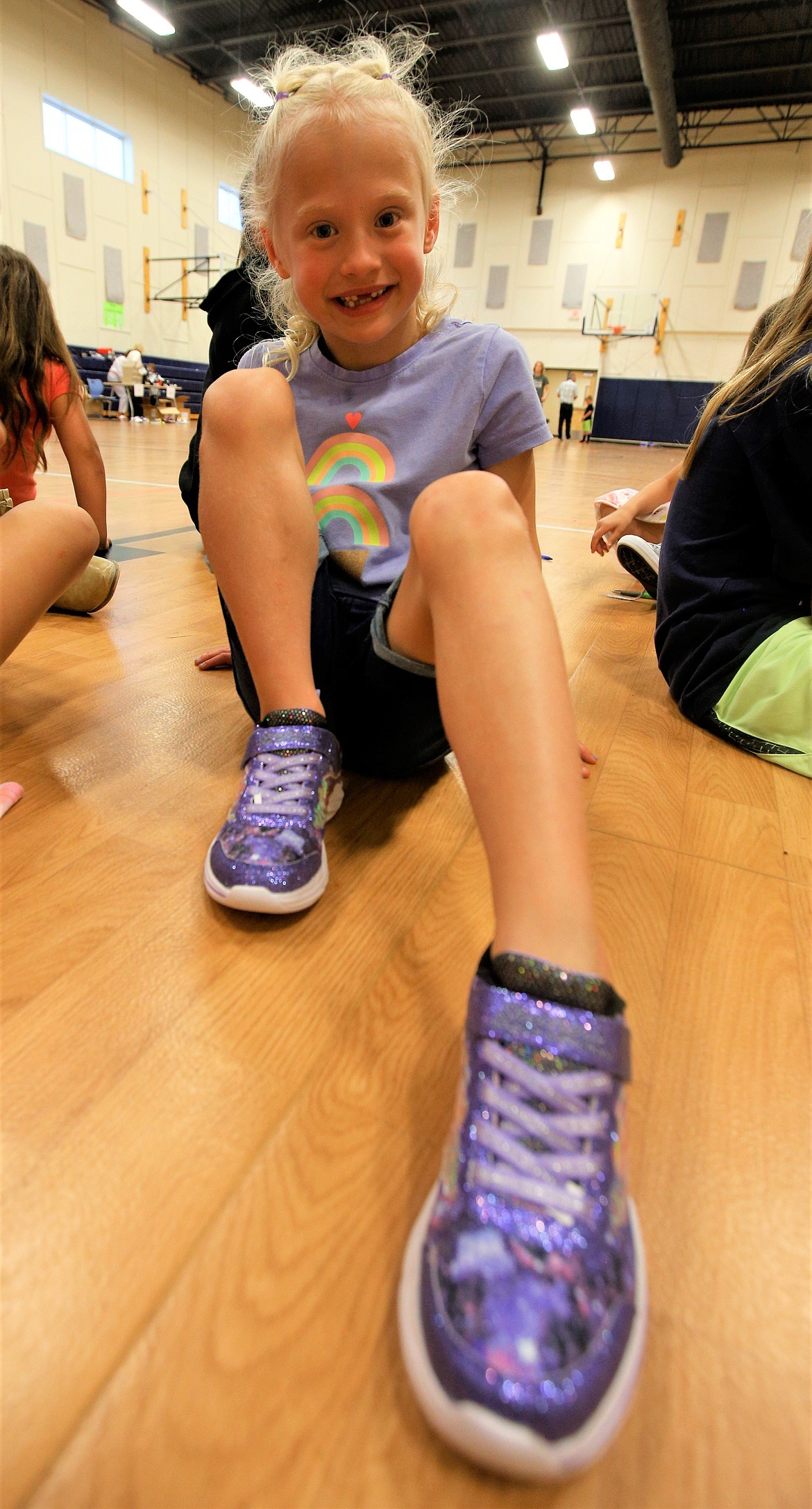 Amelia Johnson shows off her new shoes at the Lola and Duane Hagadone Boys and Girls Club of Kootenai County on Tuesday.