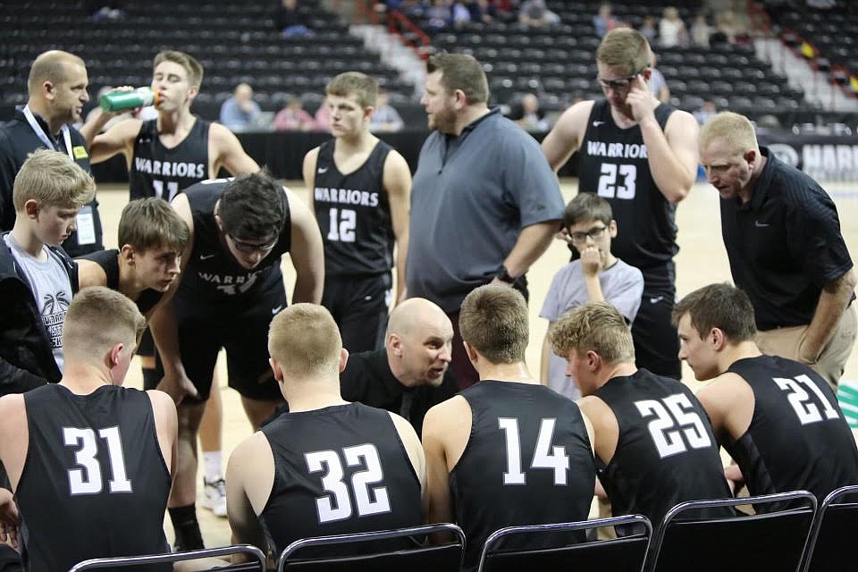 ACH boys basketball Head Coach Graham Grindy talks with players during a state tournament game. This past season was Grindy’s 10th year as head coach of the Warriors.