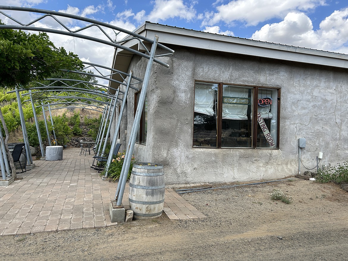 The building where White Heron Cellars wines are created is surrounded by their vineyard. Inside sits the wine-distilling equipment and crates of freshly bottled wine.