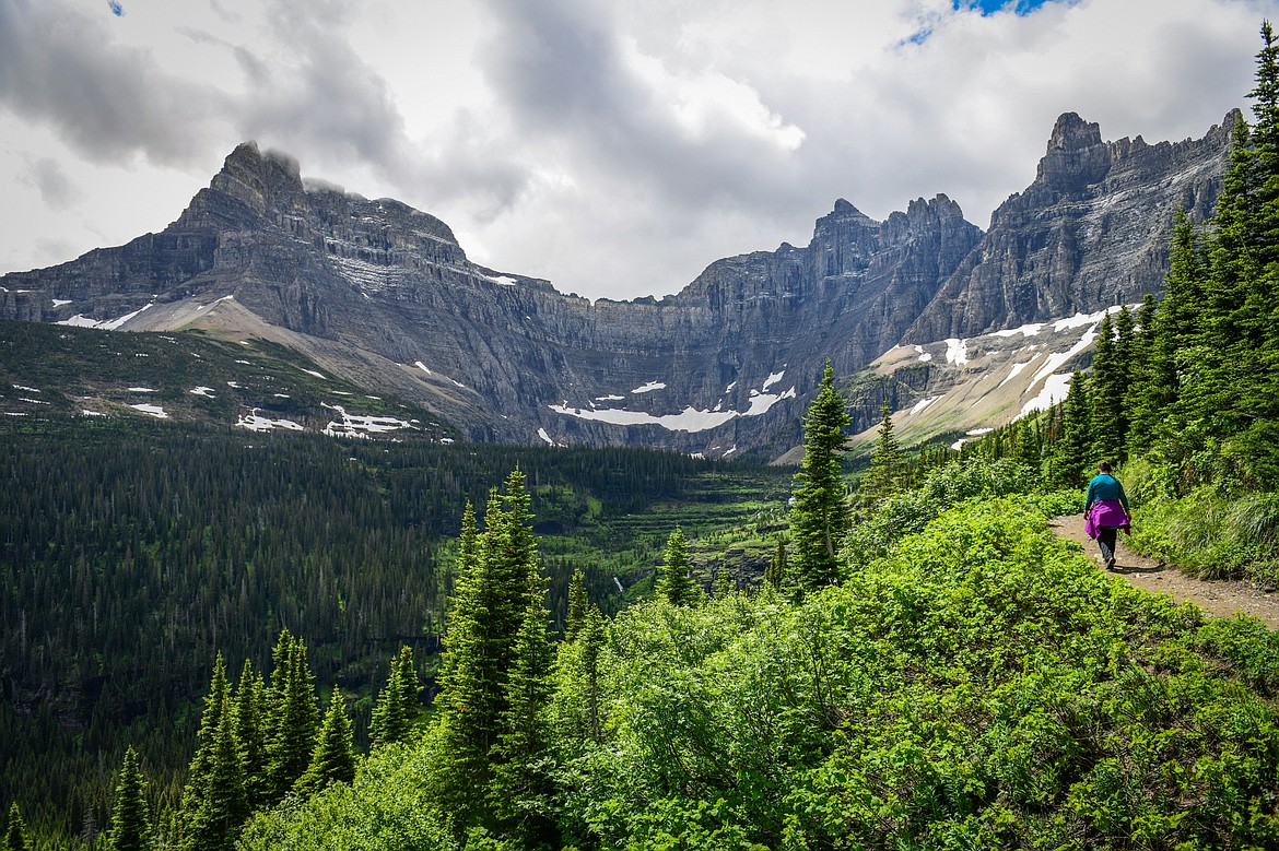 Hiking along the Iceberg Lake Trail as the Ptarmigan Wall towers in the background in Many Glacier on Sunday, June 18. (Casey Kreider/Daily Inter Lake)