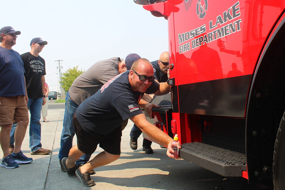 David Durfee helps push a new engine into the Moses Lake Fire Department station in 2021, when he was employed at the MLFD.