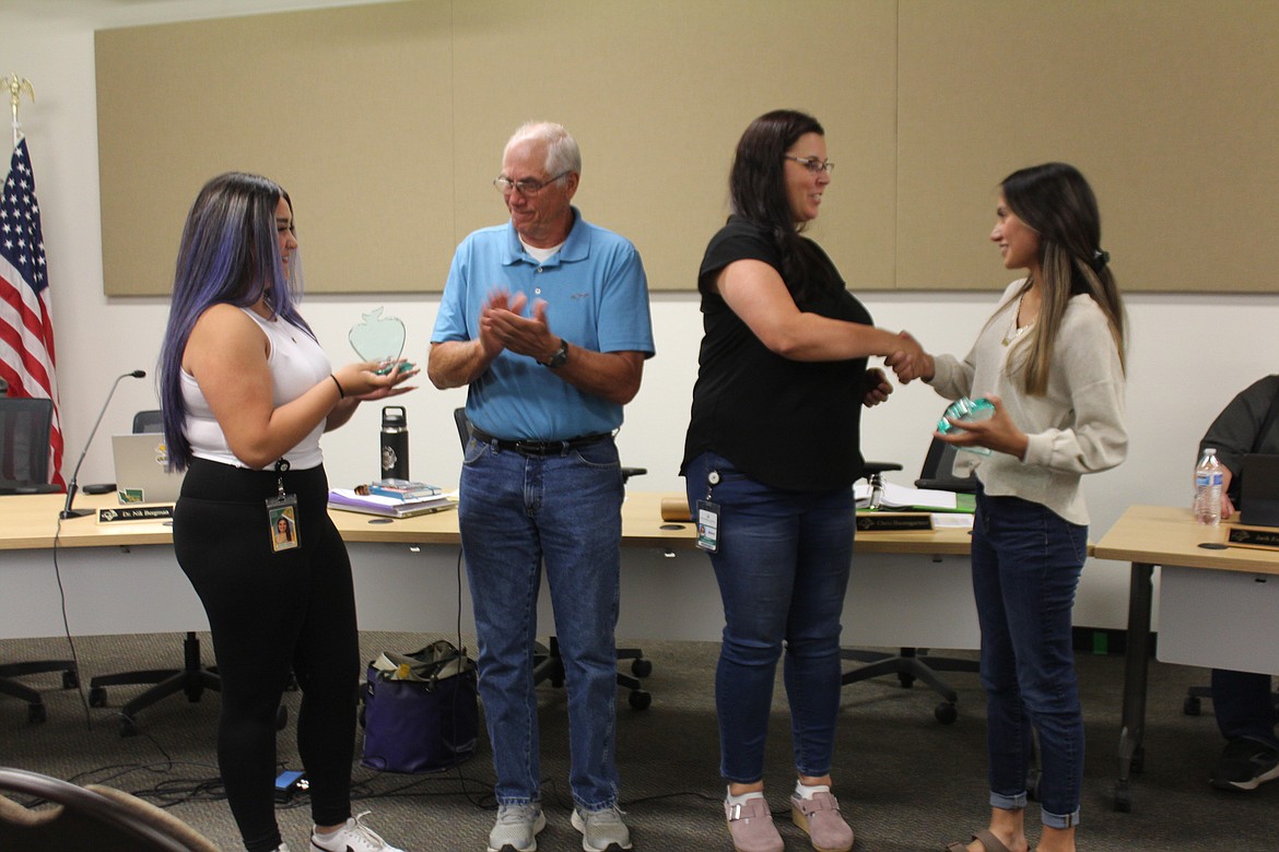 Quincy School Board members Chris Baumgartner, second from left, and Heather Folks-Lambert, second from right, present appreciation awards to graduating student representatives Brianna Herrera, left, and Nallely Uribe, right.