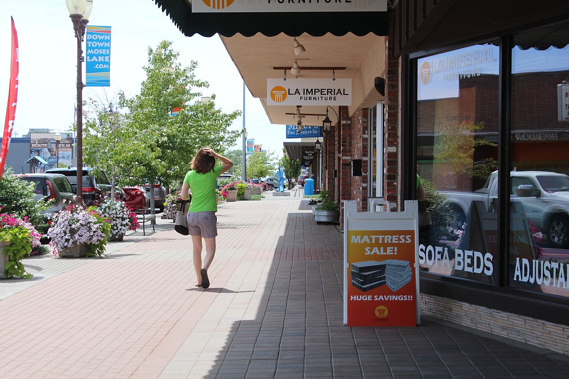 A shopper strolls down the street in Moses Lake.