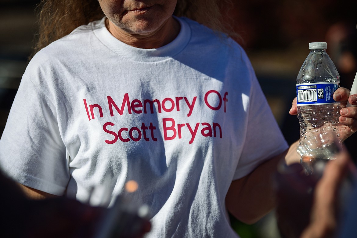 Kari Galassi, a friend of Scott Bryan, wears a shirt honoring his memory during a vigil and walk to The Warming Center in Kalispell on Saturday, July 1. Kaleb Elijah Fleck, 19, is accused of beating Bryan, a homeless man, to death outside a Kalispell gas station on the morning of June 25. (Casey Kreider/Daily Inter Lake)