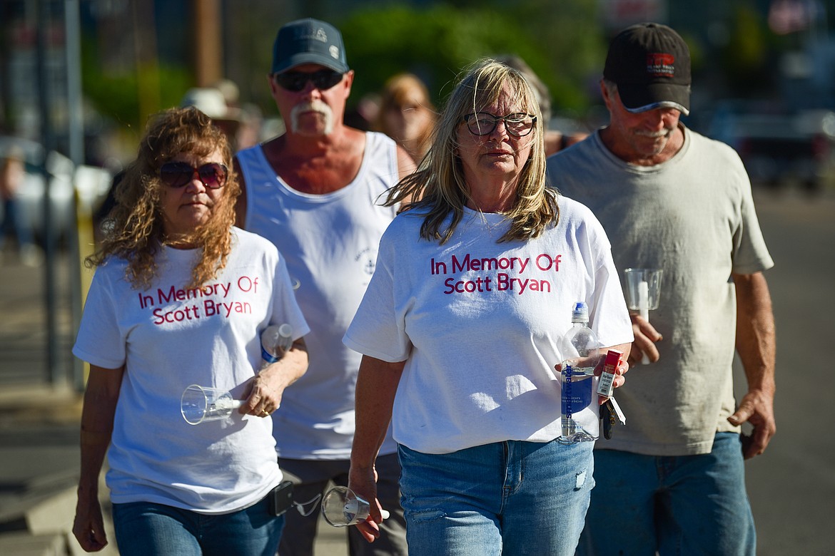 Kari Galassi, left, and Patty Longstreth, friends of Scott Bryan,  wear shirts honoring his memory during a vigil and walk to The Warming Center in Kalispell on Saturday, July 1. Kaleb Elijah Fleck, 19, is accused of beating Bryan, a homeless man, to death outside a Kalispell gas station on the morning of June 25. (Casey Kreider/Daily Inter Lake)