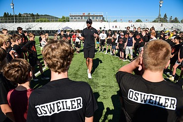 Former NFL and Flathead Braves quarterback Brock Osweiler speaks with campers at the start of a pair of free football camps hosted by Osweiler at Legends Stadium in Kalispell on Saturday, July 1. (Casey Kreider/Daily Inter Lake)