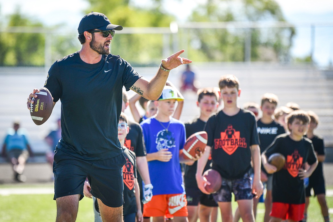 Former NFL and Flathead Braves quarterback Brock Osweiler leads quarterback drills during a pair of free football camps hosted by Osweiler at Legends Stadium in Kalispell on Saturday, July 1. (Casey Kreider/Daily Inter Lake)